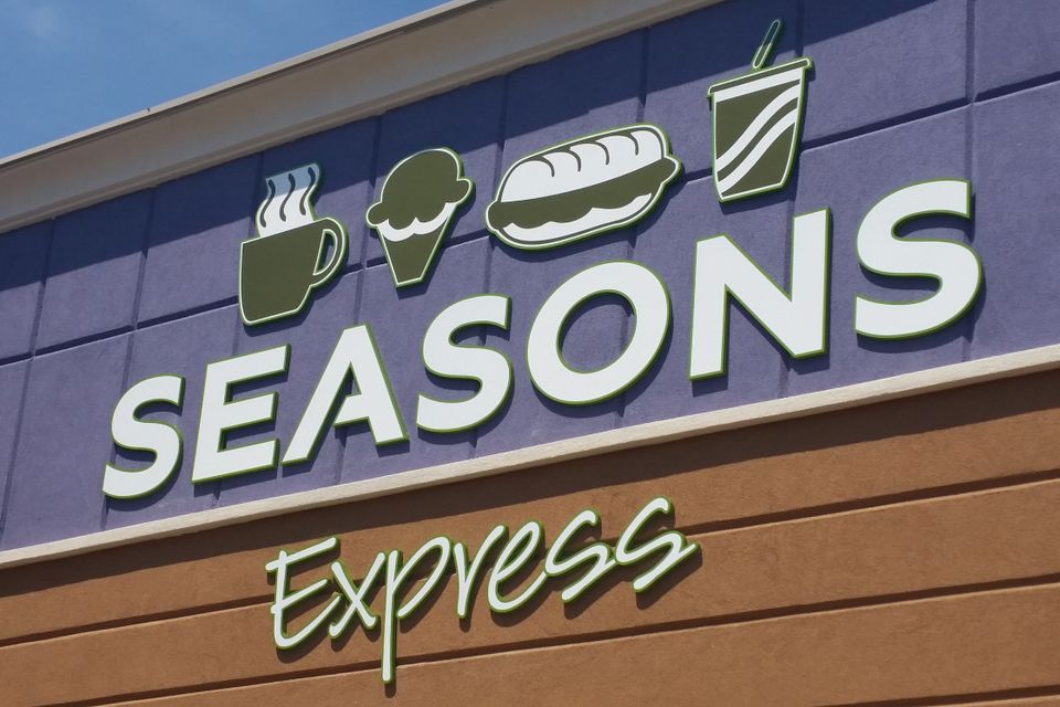 Dimensional letters reading Seasons Express with food icons mounted on a storefront facade
