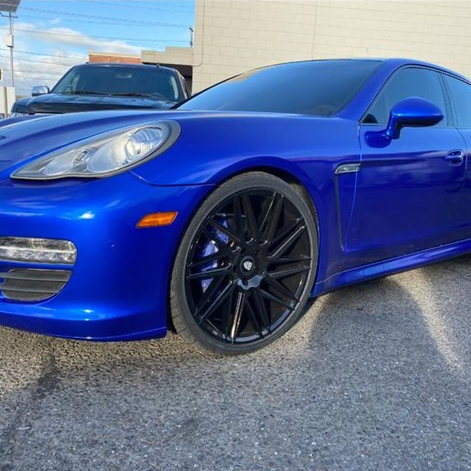 Blue sports car in a parking lot for gallery