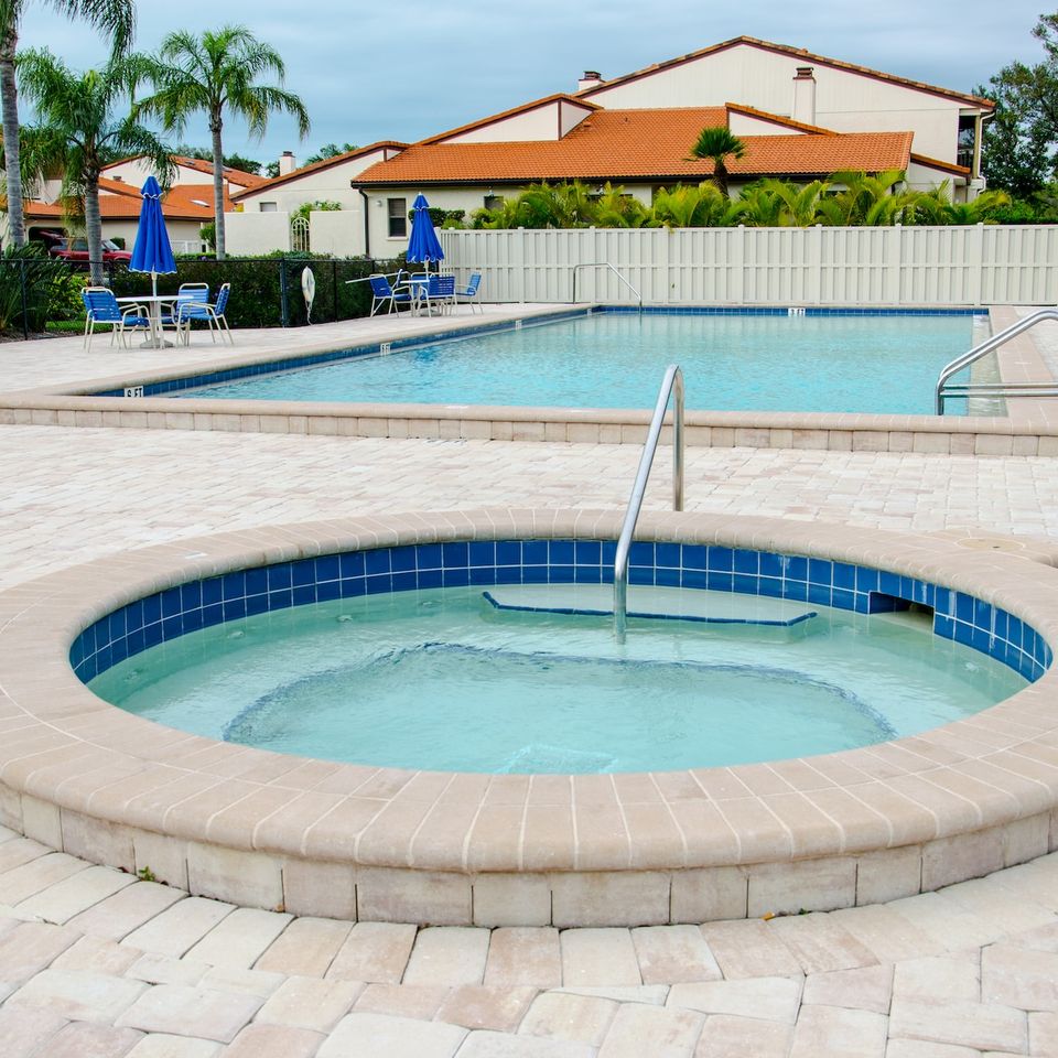 High-end masonry pool coping and custom stone surround for a luxury backyard swimming pool installation by Roseville Concrete Solutions.