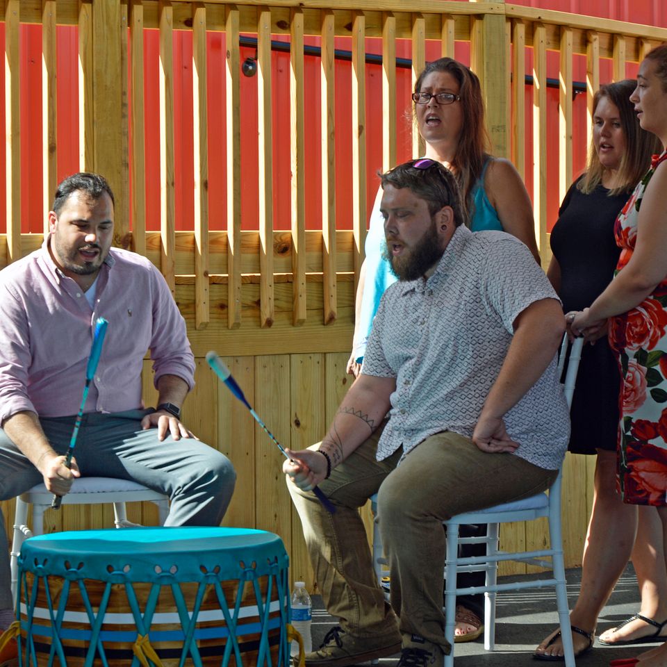 Tribal members sing the welcome song to begin the ribbon cutting ceremony