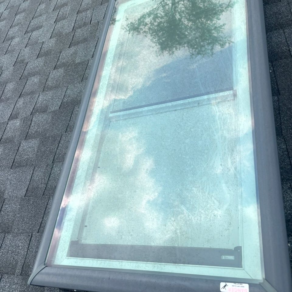 Dirty skylight glass with buildup on shingle roof before exterior cleaning in Harrisburg PA