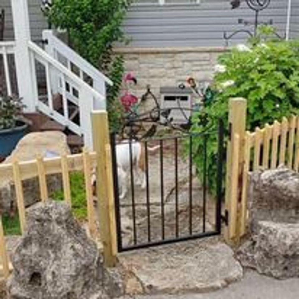 custom wooden picket fence with decorative metal gate