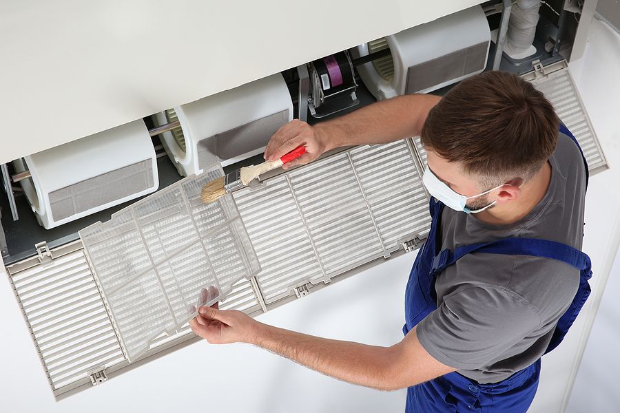 Infinite Air Technician Cleaning Split Unit Air Vent in Raleigh