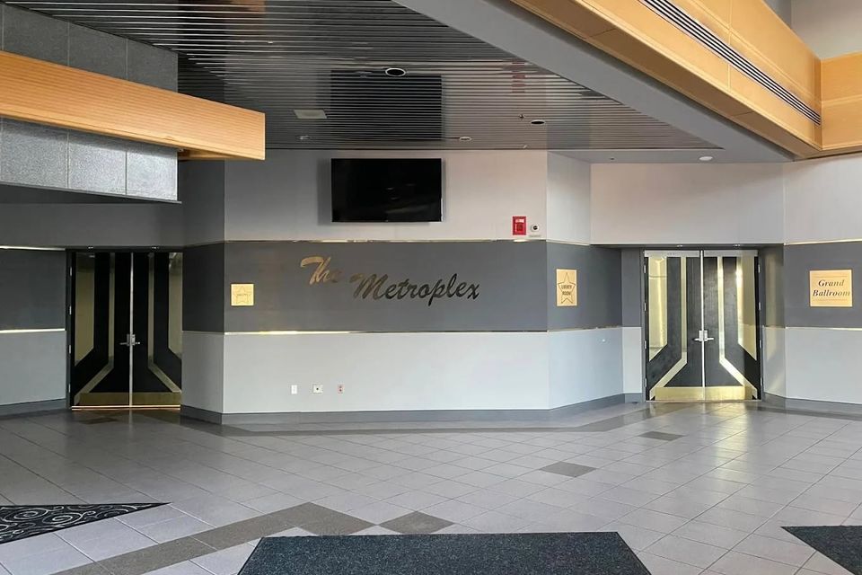 Lobby entrance of The Metroplex Expo Center in Girard with signage and event access doors