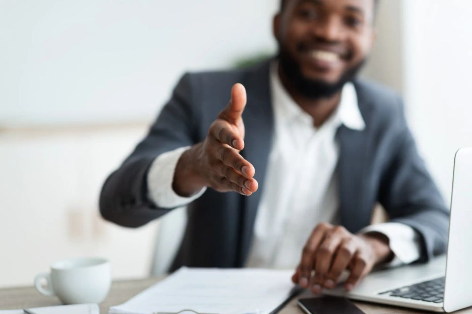 African american entrepreneur extending hand to shake