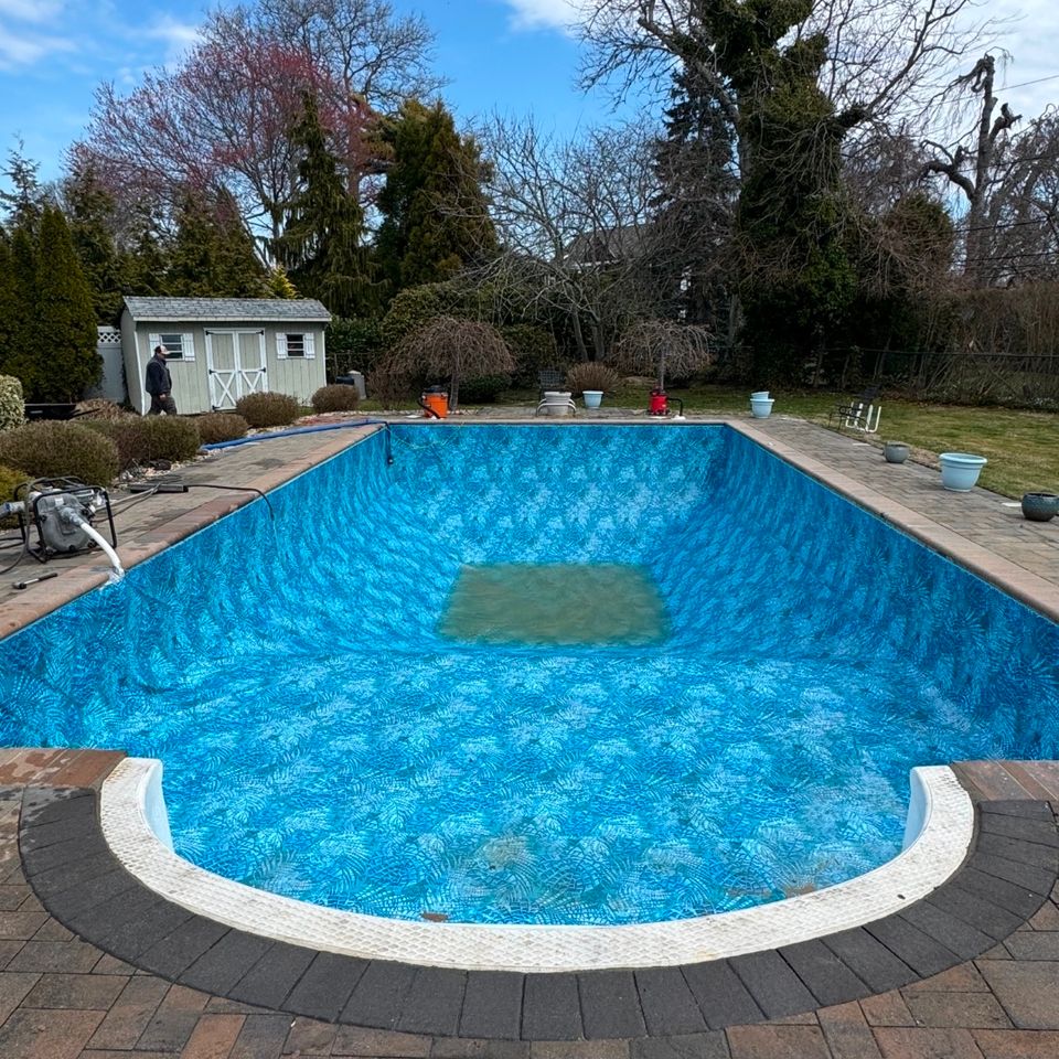 Rectangular inground pool with fresh patterned liner and Roman step end during a liner replacement