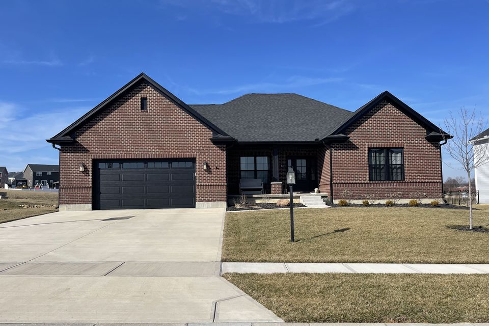 Brick ranch-style home with a newly installed gray architectural asphalt shingle roof by E & D Roofing, Inc.