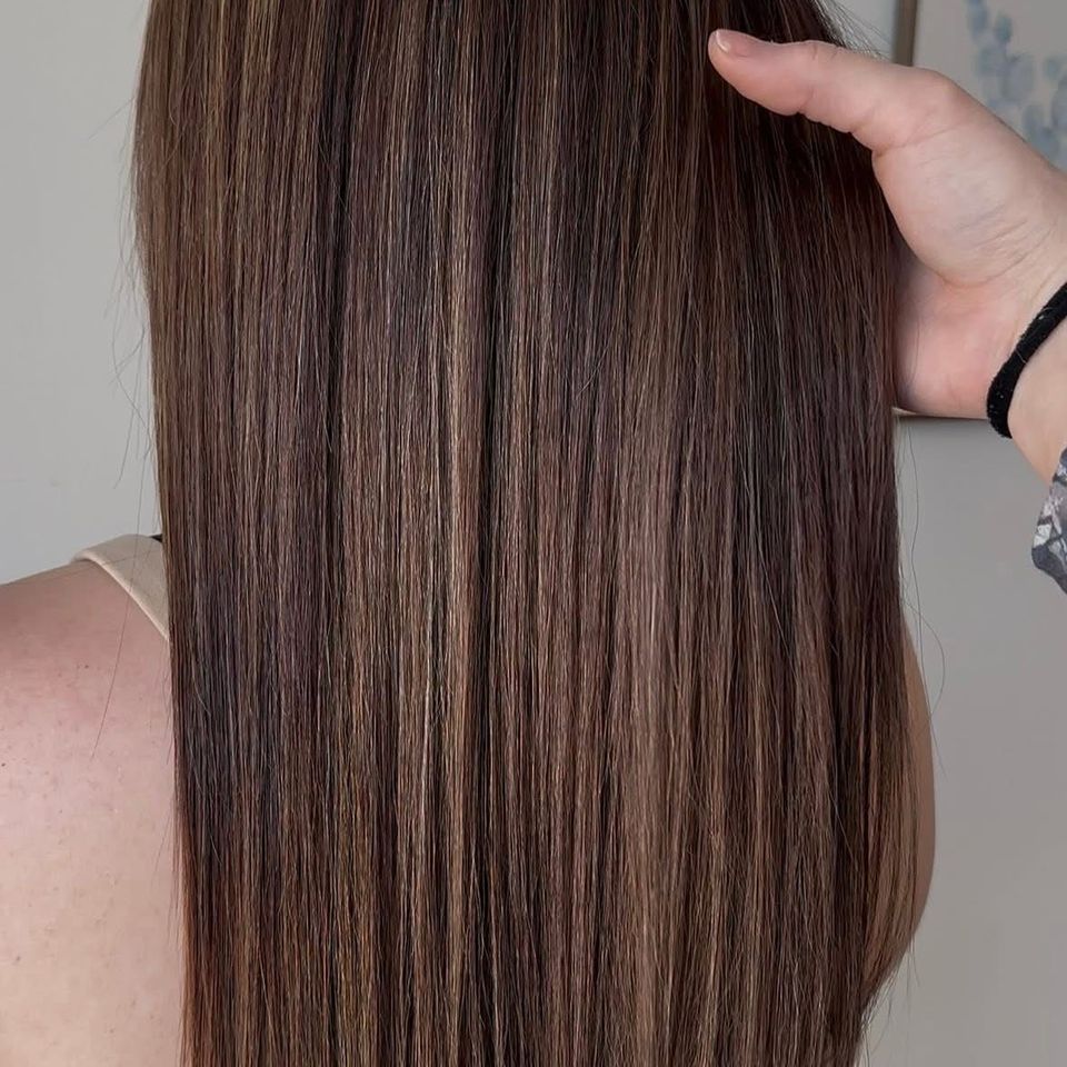 Long sleek straight brown hair with subtle caramel dimension after color and styling in Columbiana AL