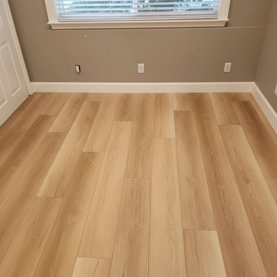 High quality luxury vinyl plank (lvp) flooring installation by concord carpet and hardwood featuring a modern light oak finish and professional white baseboard trim.