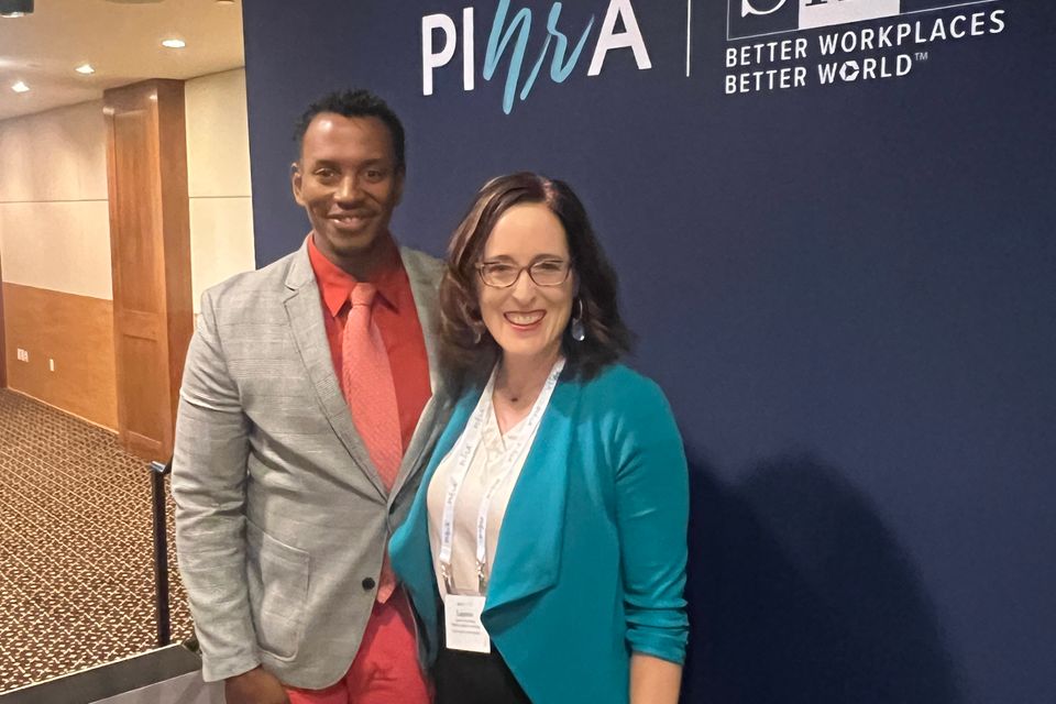 Man and woman standing smiling