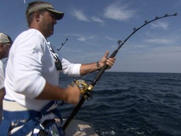 Man fishing off the side of boat