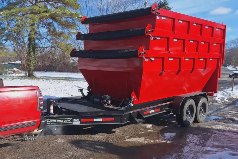 Large Rent-A-Man Dumpster Rentals dumpster mounted on a trailer.