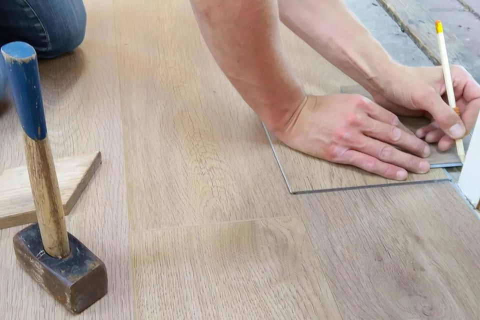 man installing flooring