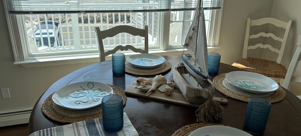 Coastal dining table with nautical decor inside Ocean View Motel suite