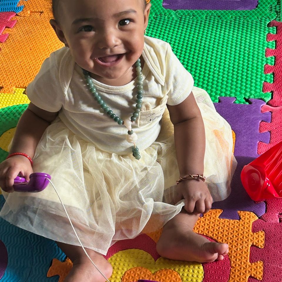 Baby girl sitting on mat