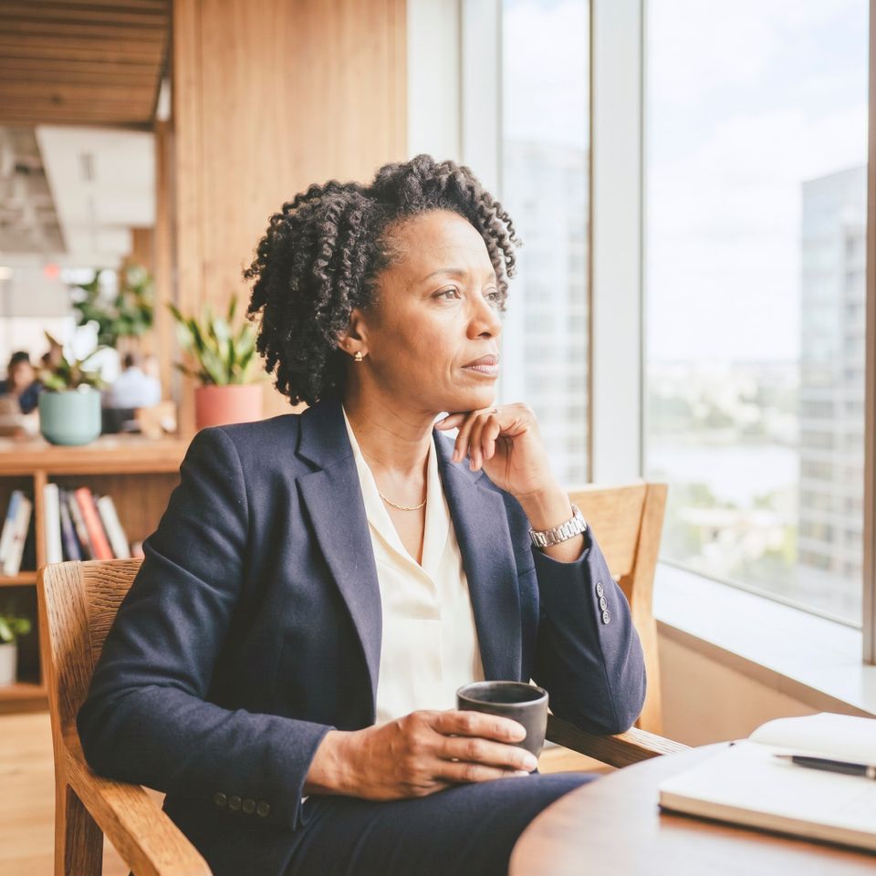 Thoughtful person in office lounge 202608102156