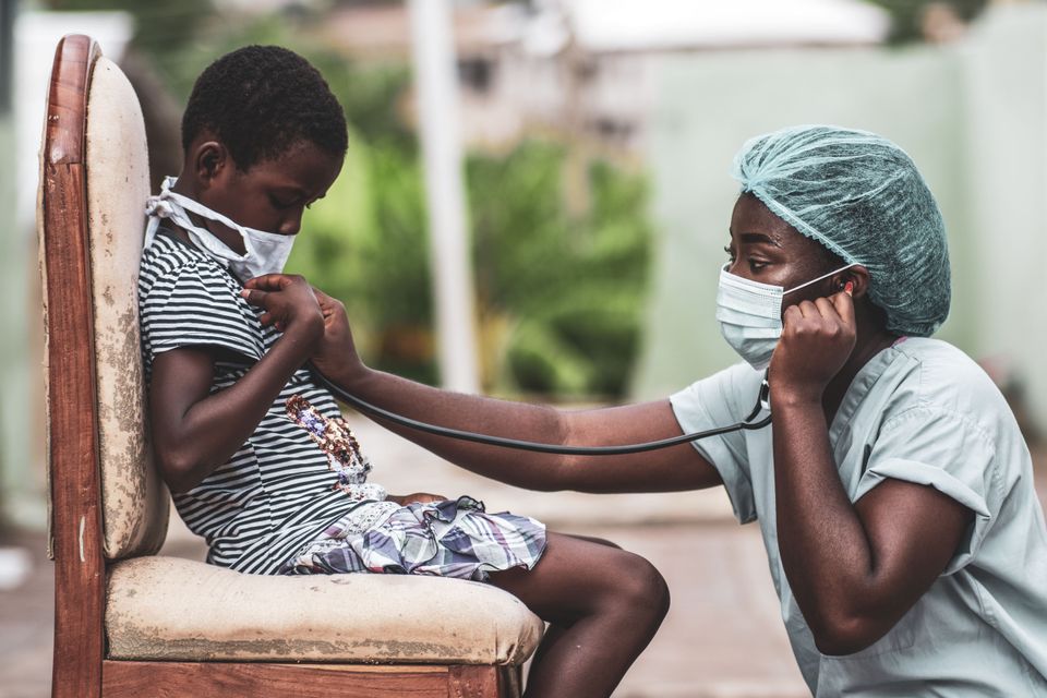 African american boy getting checkup by doctor min