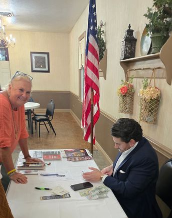 Claudia gets her book signed by nick adams