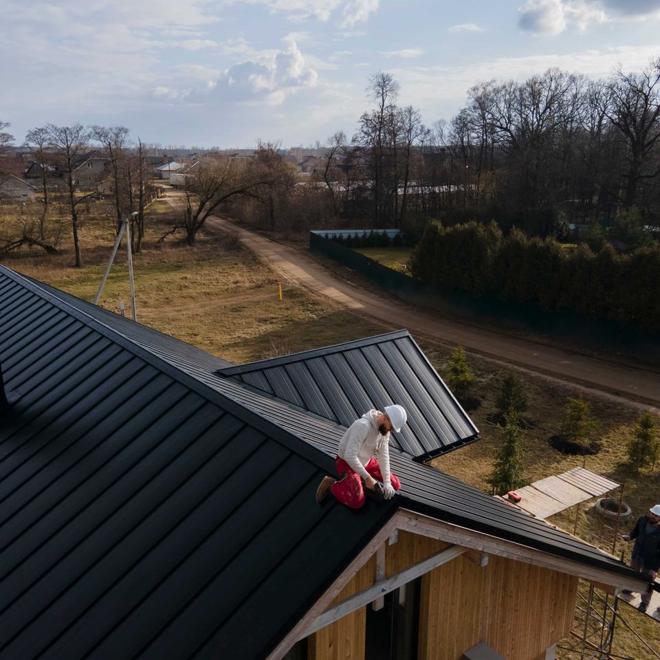 Long shot roofer working with helmet (2) (1)