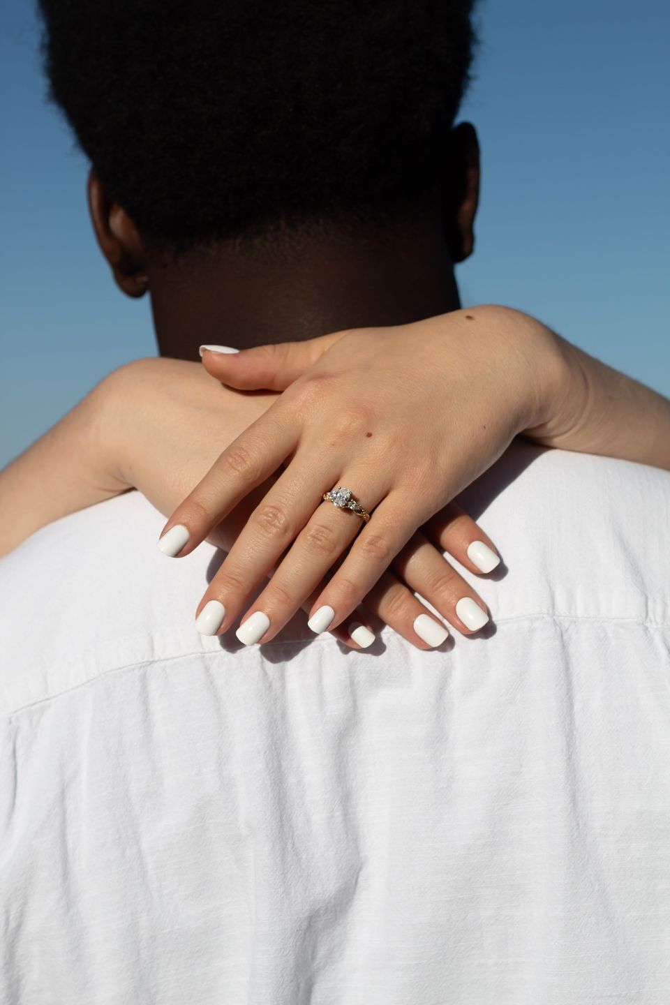 Engagement ring on hands around neck