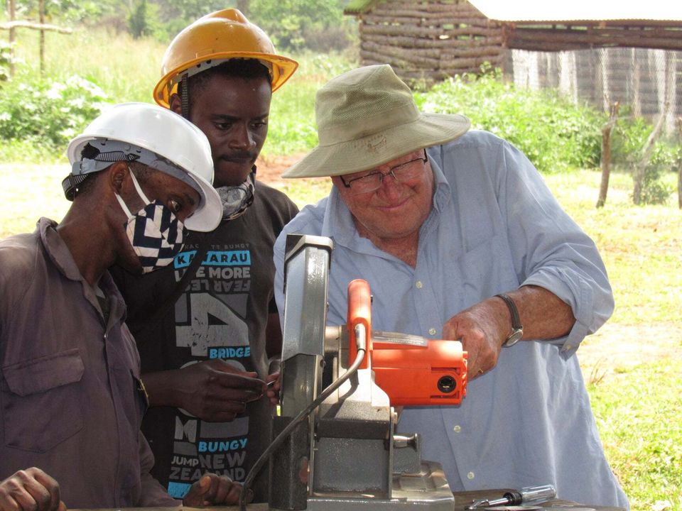 Adjusting a scroll saw for construction work in uganda