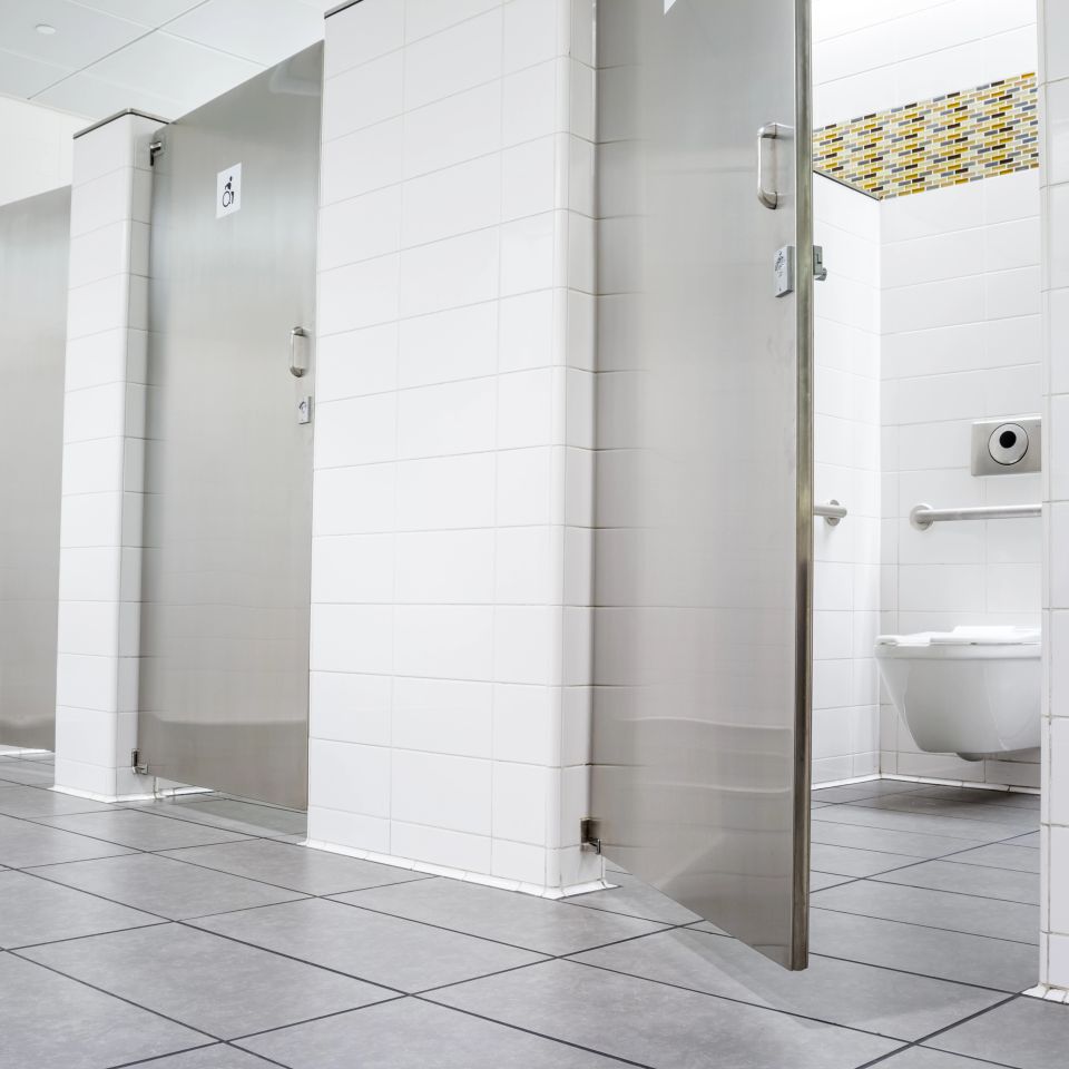 Public restroom with white walls and stalls