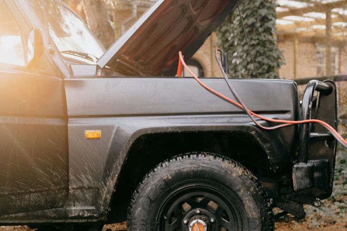 Technician inspecting vehicle electrical components during diagnostic testing in Missouri City, TX