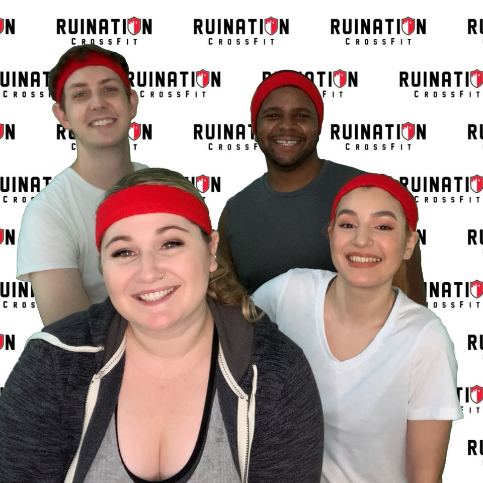 Corporate event photo booth with custom branded backdrop and group posing.