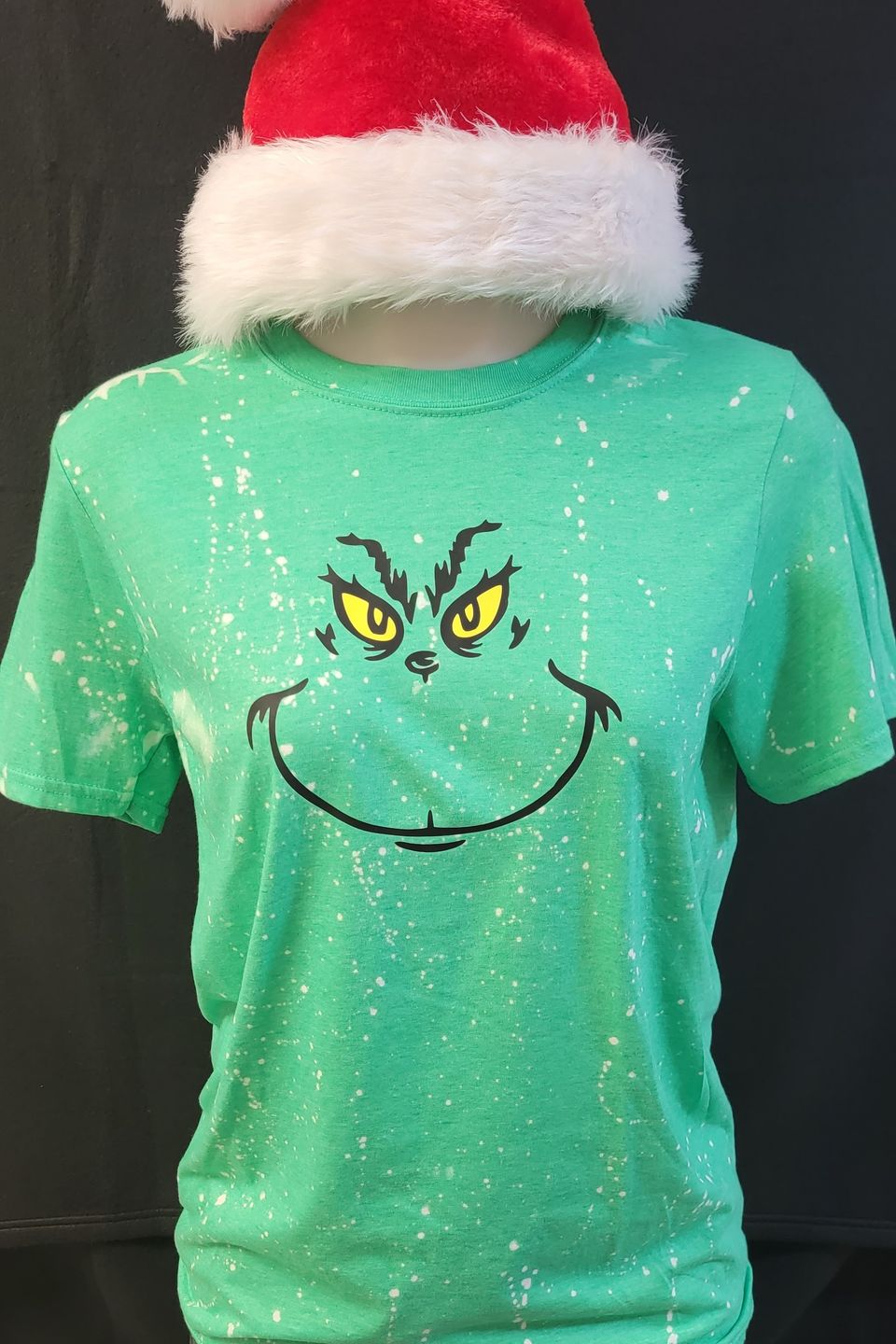 "DTF Direct-to-Film" example - The Grinch holiday design on a green t-shirt