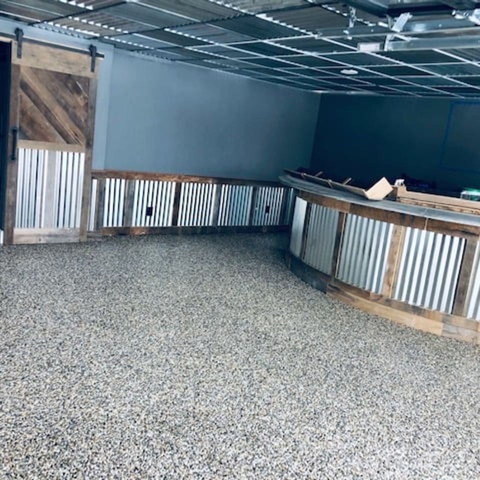 Commercial-style basement featuring an EverStone decorative stone flooring system with a seamless finish.