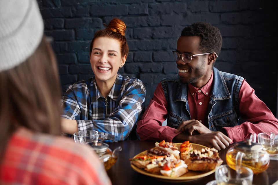 Three best friends enjoying nice conversation lunch modern cafe interior