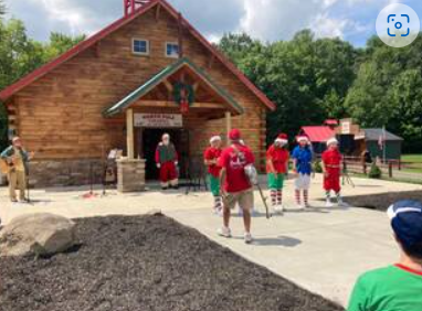 Families and participants gathered outside a cabin during a Down Syndrome Association of the Valley event.