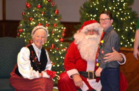 Participant posing with Santa Claus during a Down Syndrome Association of the Valley holiday celebration.