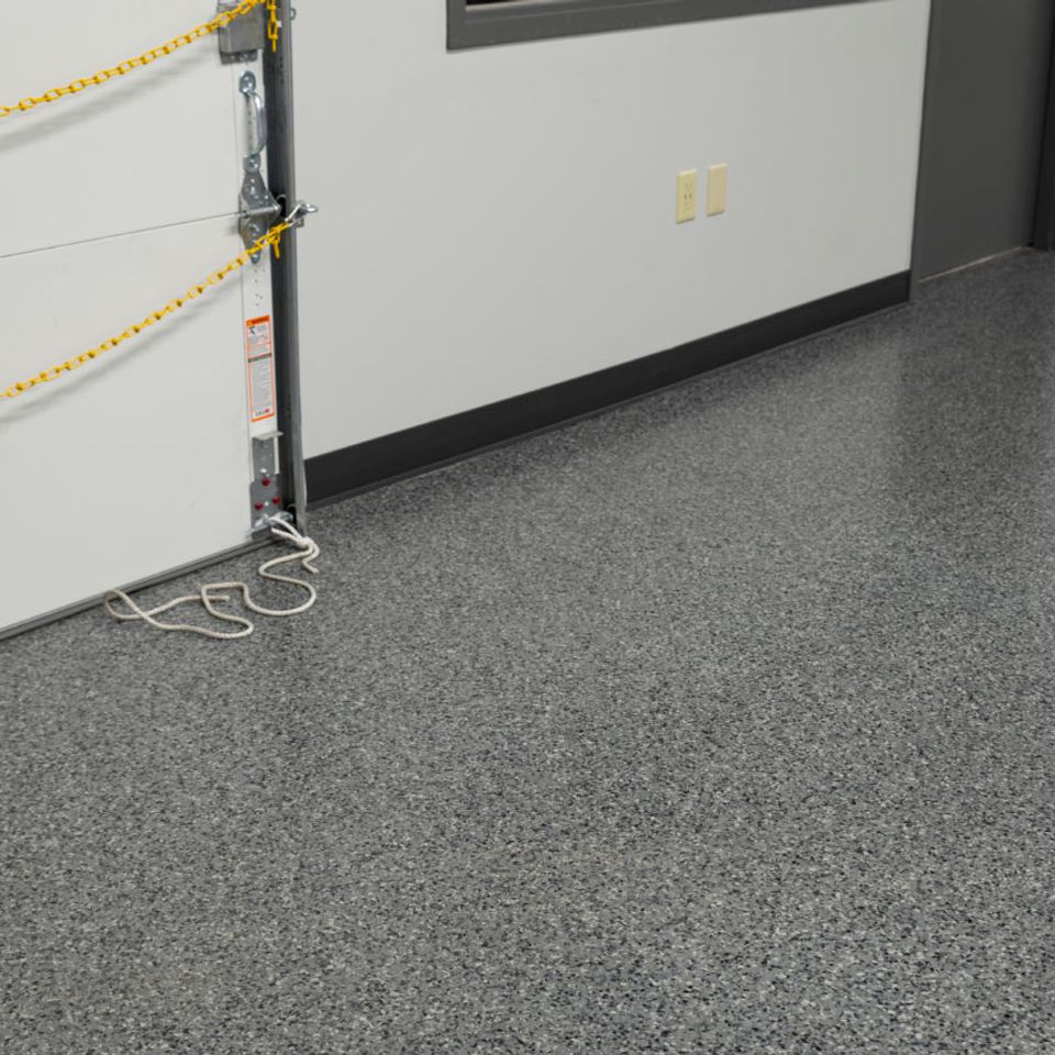 Garage interior with gray EverStone Flakes flooring.