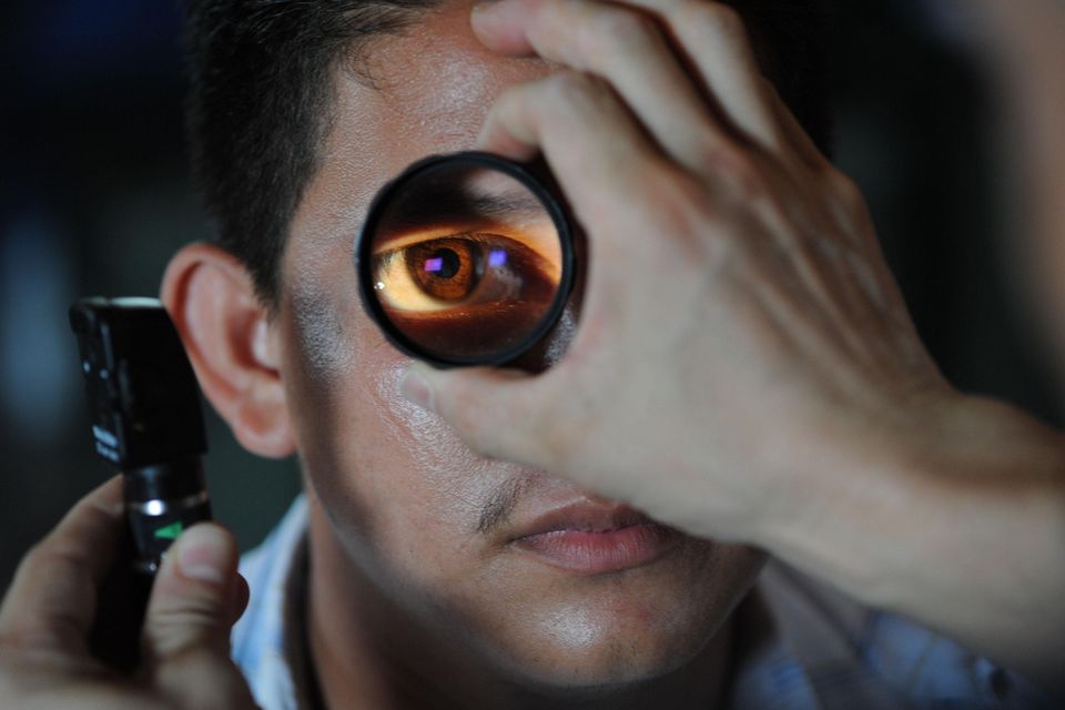 Guy having an eye exam done. Close up of his eye in Cypress, Texas