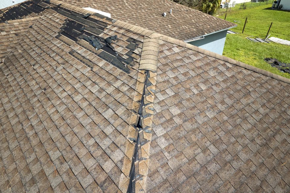 damaged roof with missing shingles