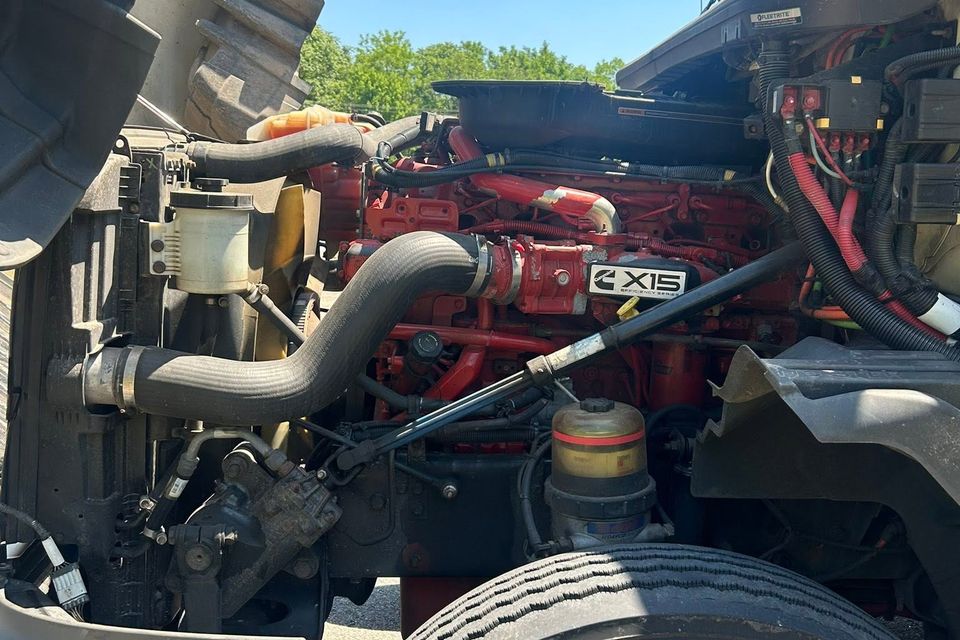 Cummins X15 diesel engine exposed under raised hood during semi-truck repair in Arab Alabama