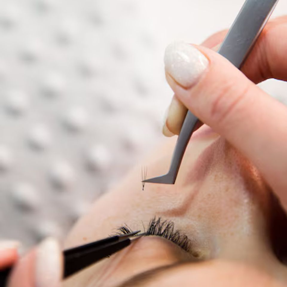 Eyelash extension procedure woman eye with long eyelashes lashes close up macro selective focus 165293 495