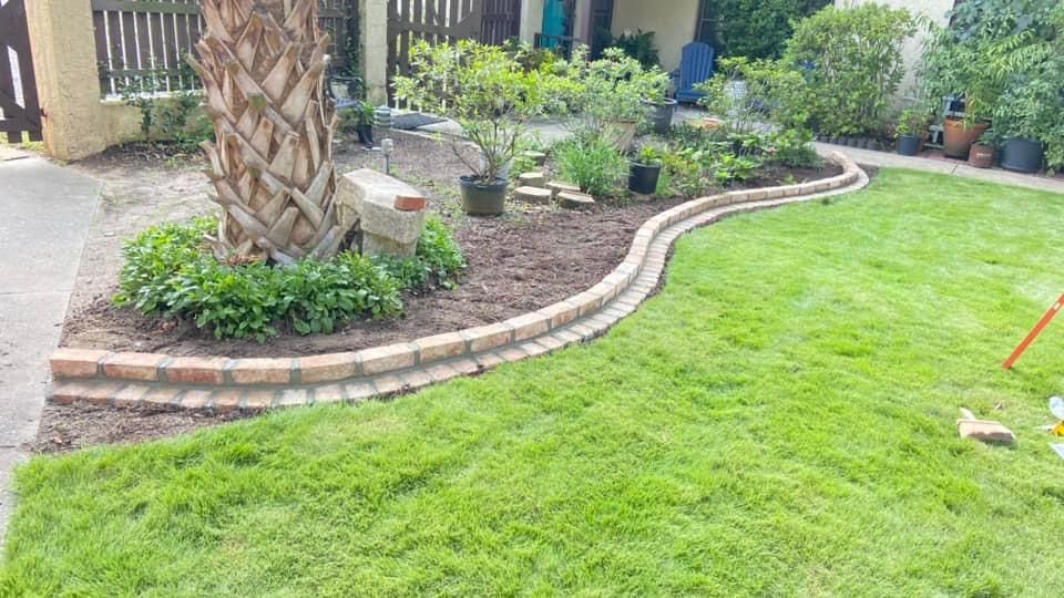 "Decorative stone landscape edging installed by Gabino Landscaping in Myrtle Beach, South Carolina."