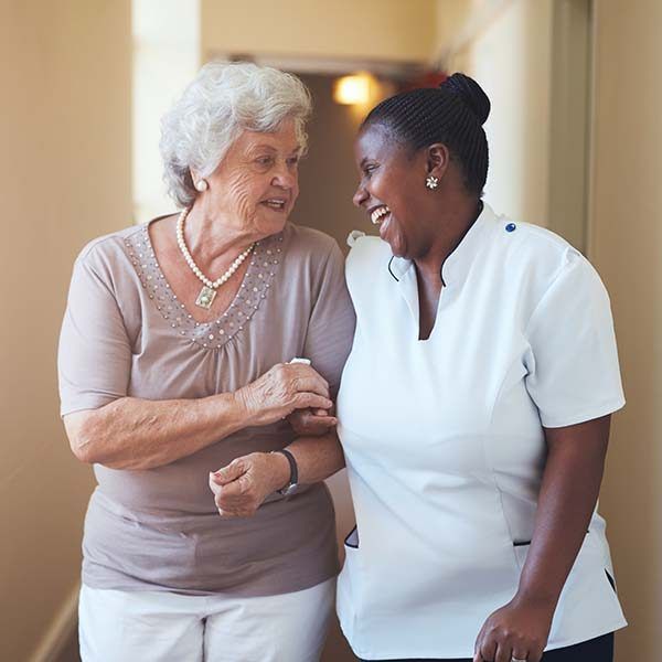 Happy female caregiver and senior woman walking to pvhuntk pcxd6hngyt1mot7n60ybtuyvwhmk42om1uin0icsj4