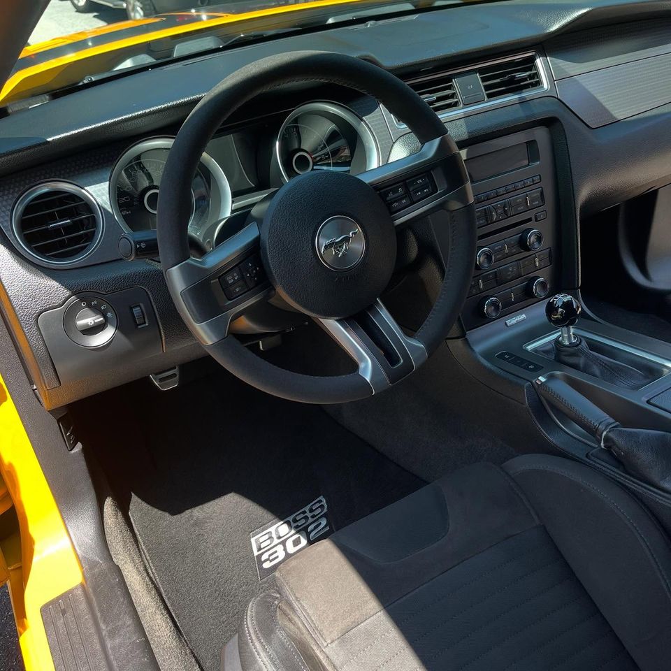 Clean Mustang Boss 302 dashboard, steering wheel, and floor mats after interior cleaning at a Wilmington home