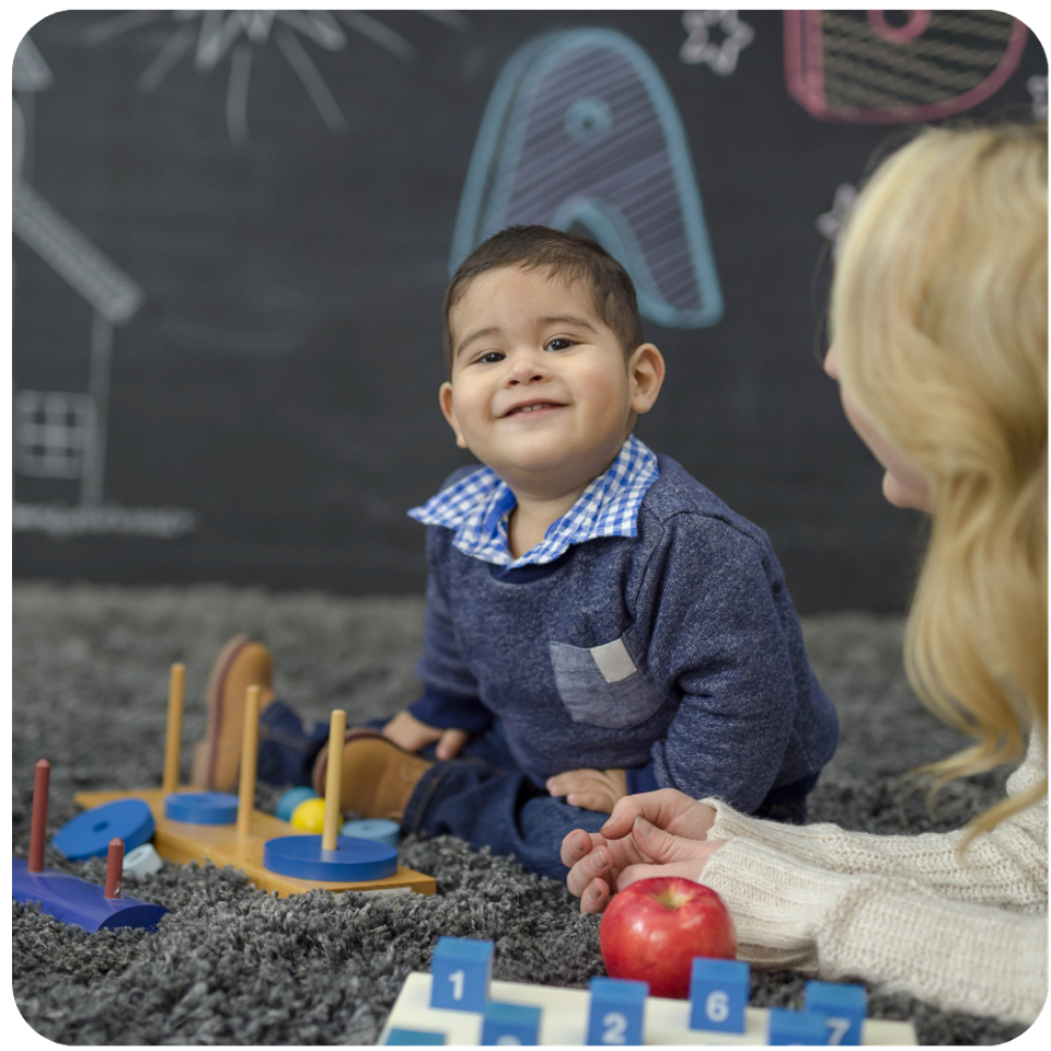 Toddler hispanic boy and teacher