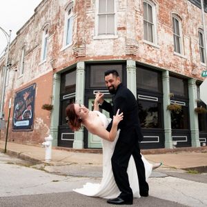 Groom dipping bride outside coleman vault