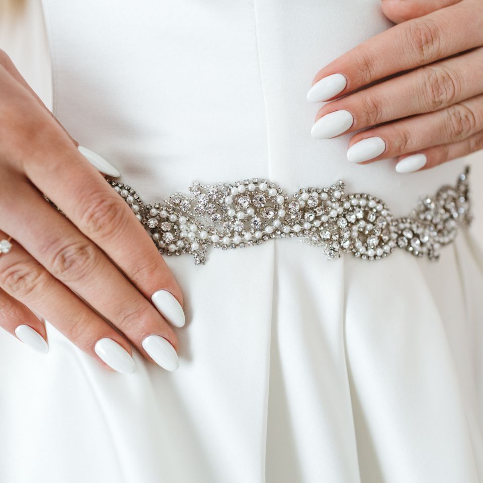 white dress adorned with gemstones and rhinestone bling
