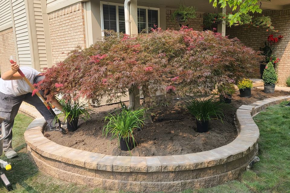 Vic's Landscaping working on plants for a client