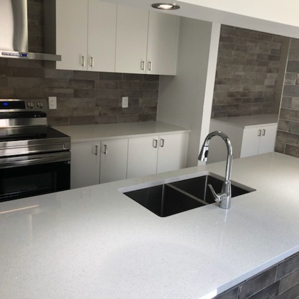 White counter built around sink.