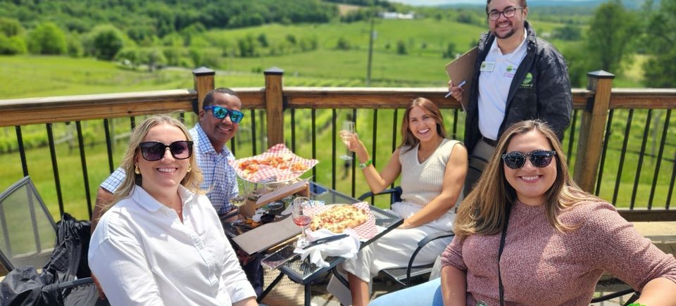 Visitors enjoying picturesque vineyard landscapes while wine tasting
