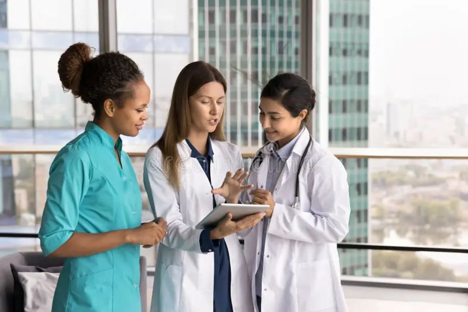 Diversity medicine confident young woman doctor multicultural team leader consult female colleagues explain telehealth app work 374465882