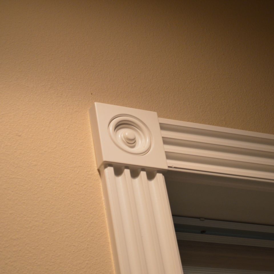 Fluted door casing with decorative rosette corner block from a custom home finish carpentry package
