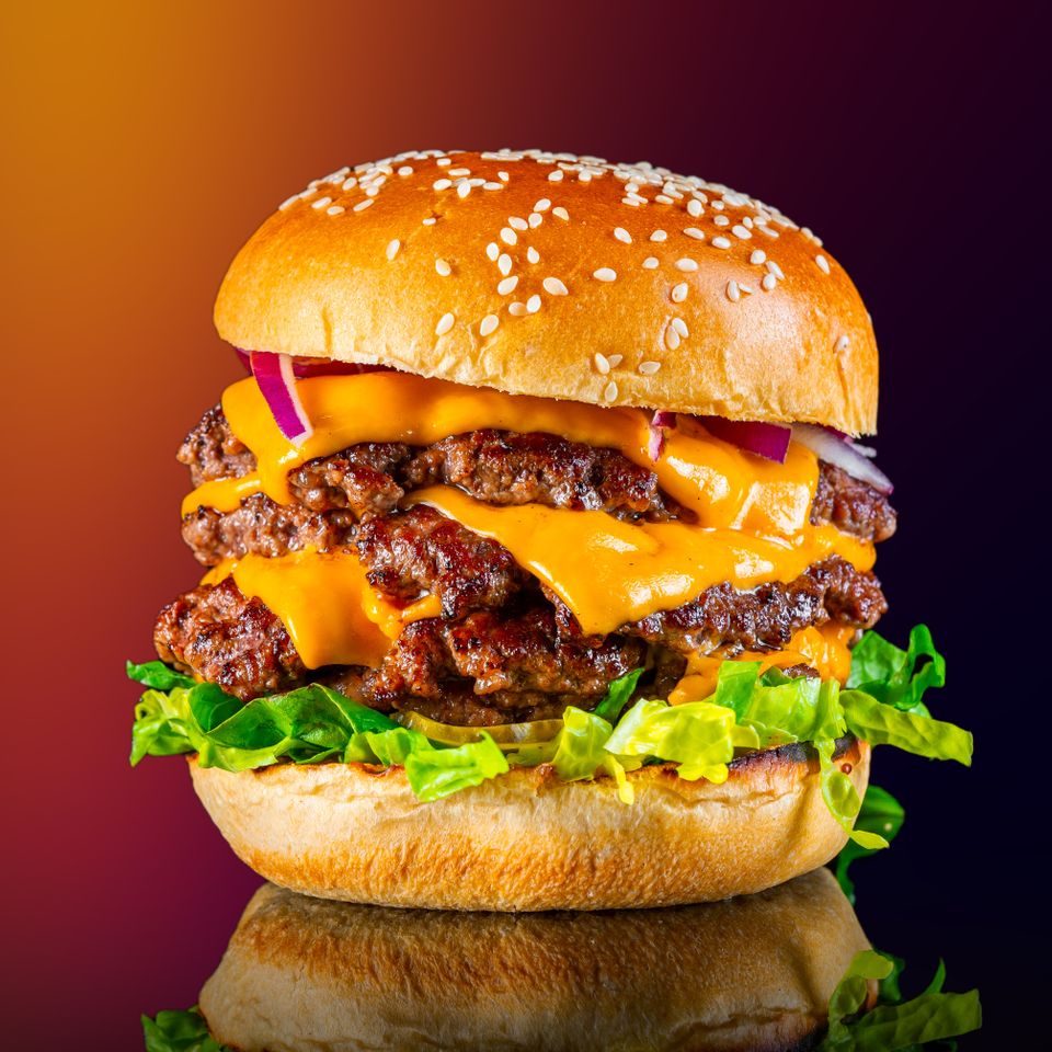 Closeup view of a tasty tower cheeseburger isolate 2025 02 11 16 41 04 utc